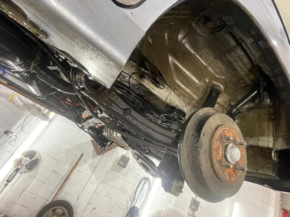 Rear suspension and arch with the liner removed, from below