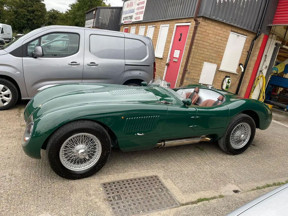 The same sports car finished in British racing green with wire wheels
